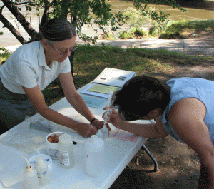 GVCA Secretary Joyce Wizer and volunteer Lisa Bracken collect water samples during a River Watch training session.