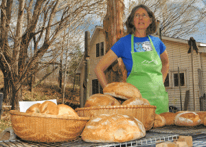 Monica Wiitanen with some of her breads at Small Potatoes Farm, outside of Paonia. Photo courtesy of Slow Food Western Slope.  Photo courtesy of Slow Food Western Slope
