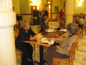 Chair Gretchen N helps Evette Lee prep her testimony